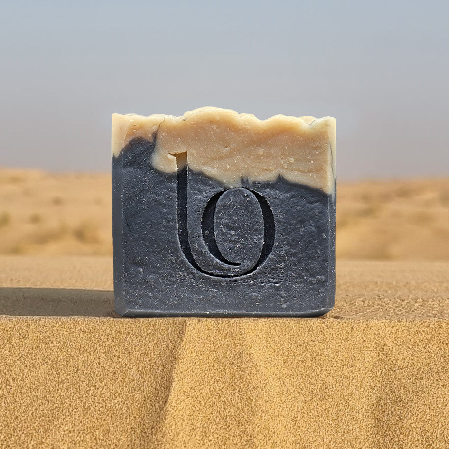 Bar of tallow soap with our logo on sand dunes