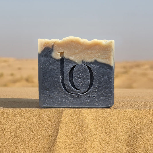 Bar of tallow soap with our logo on sand dunes
